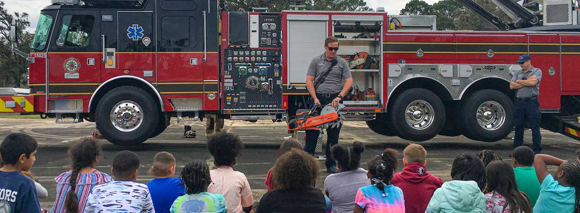Firefighter teaching kids