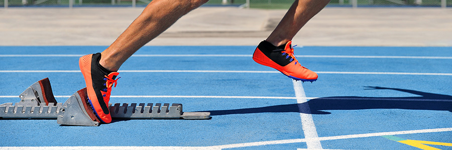 Runner's feet moving out of the starting blocks
