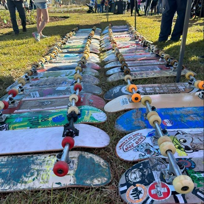 loads of skateboards waiting to be decorated and ridden lie on the ground